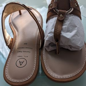 Addition Elle thong sandals. With brass ring embellishment and textured details.